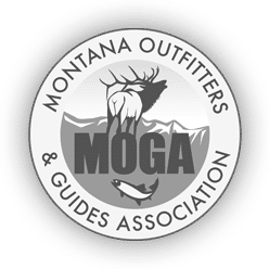 Circular logo for Montana Outfitters & Guides Association, featuring a moose, mountains, and a fish, with the acronym MOGA in bold letters—perfect for those interested in hunting property or land for sale.