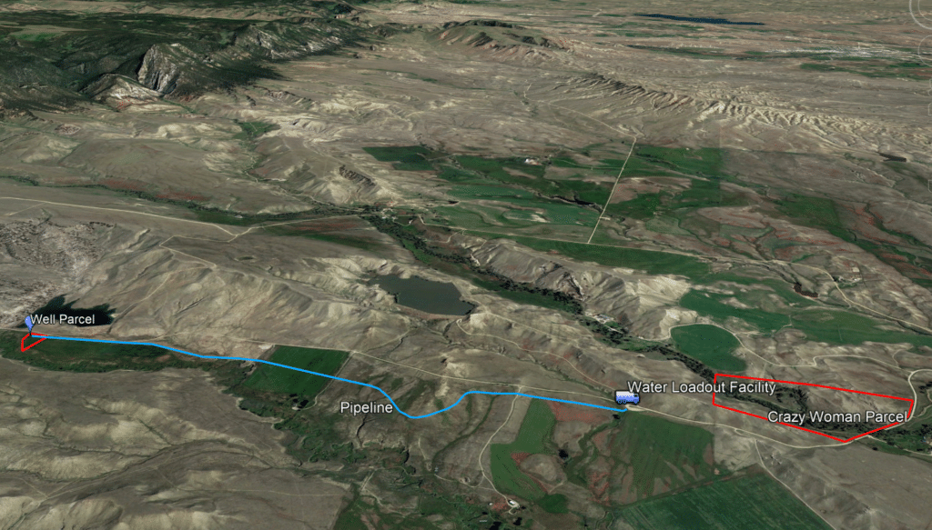 Aerial map displays a pipeline route from a Well Parcel to a Water Loadout Facility and on to the Crazy Woman Parcel, with labeled paths across rural terrain—ideal for those seeking land for sale or unique recreational land opportunities.